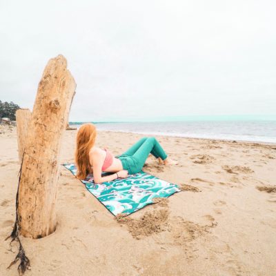 girl laying on beach towel