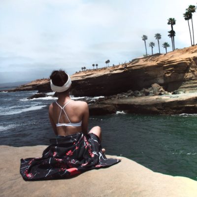 girl by ocean with towel